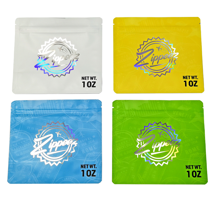 White, yellow, blue and green holographic pouches arranged to show the printed artwork