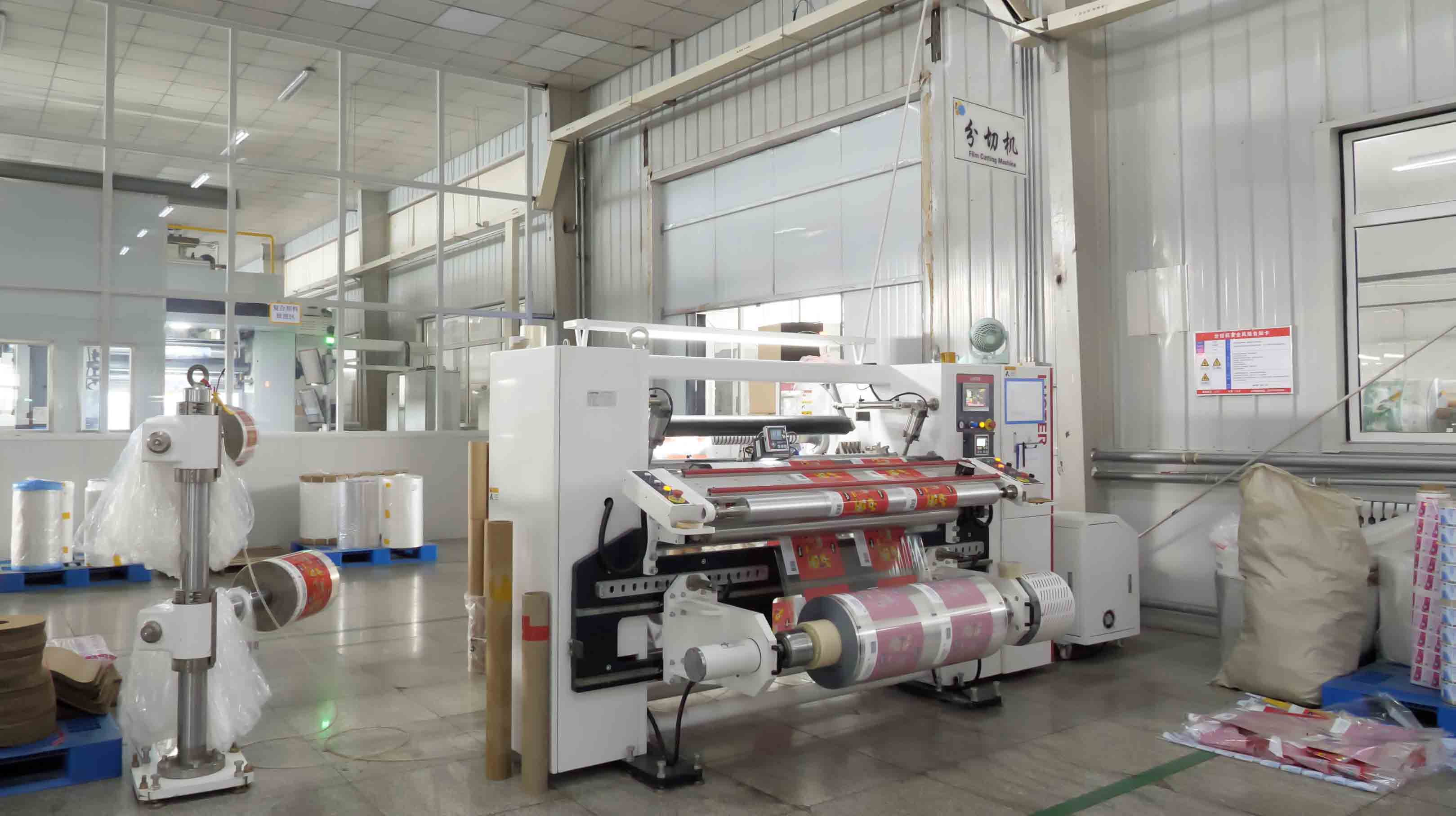 Flexible packaging converting equipment and film rolls in the workshop