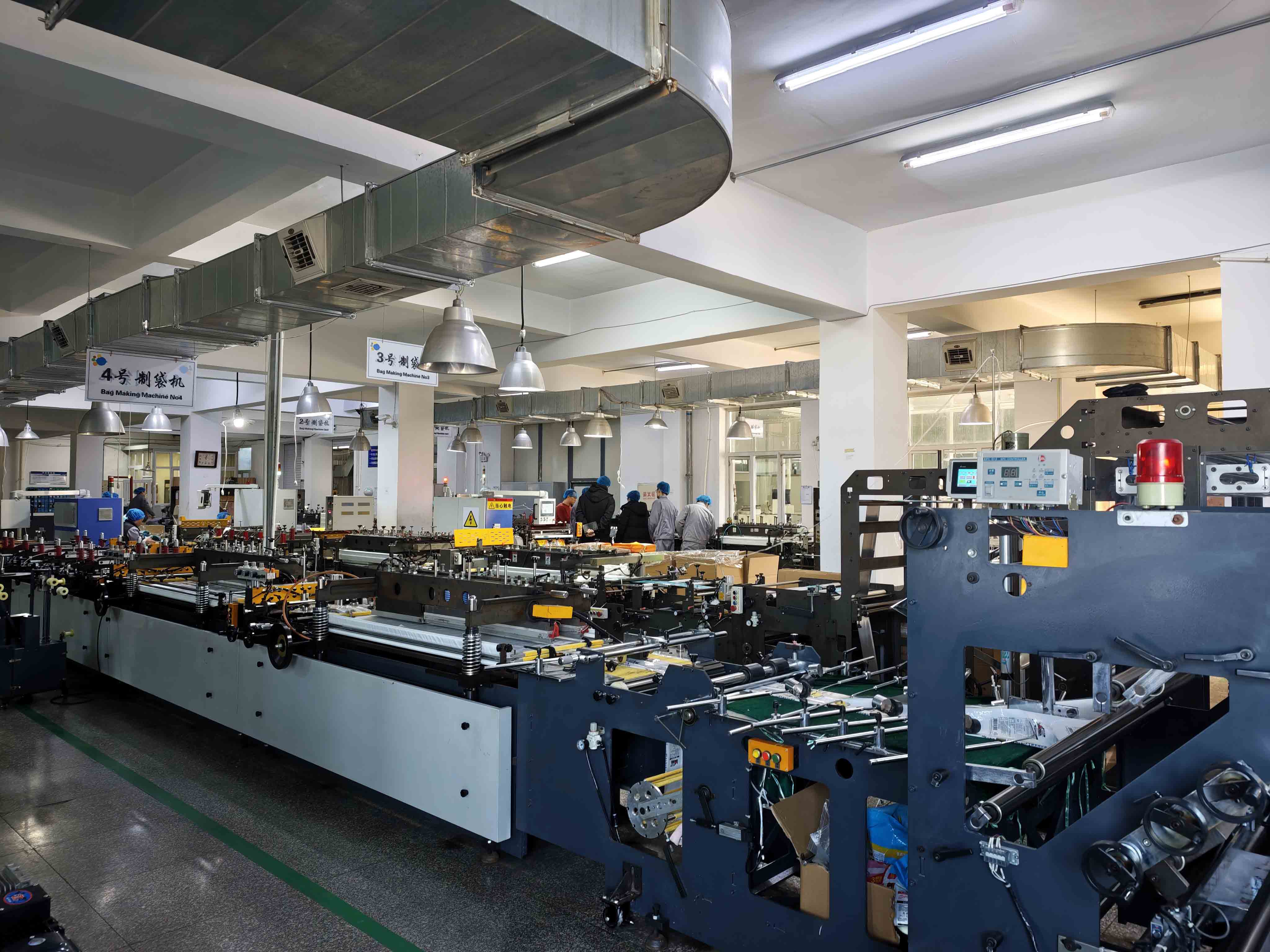 Pouch-making equipment extending across the flexible packaging workshop