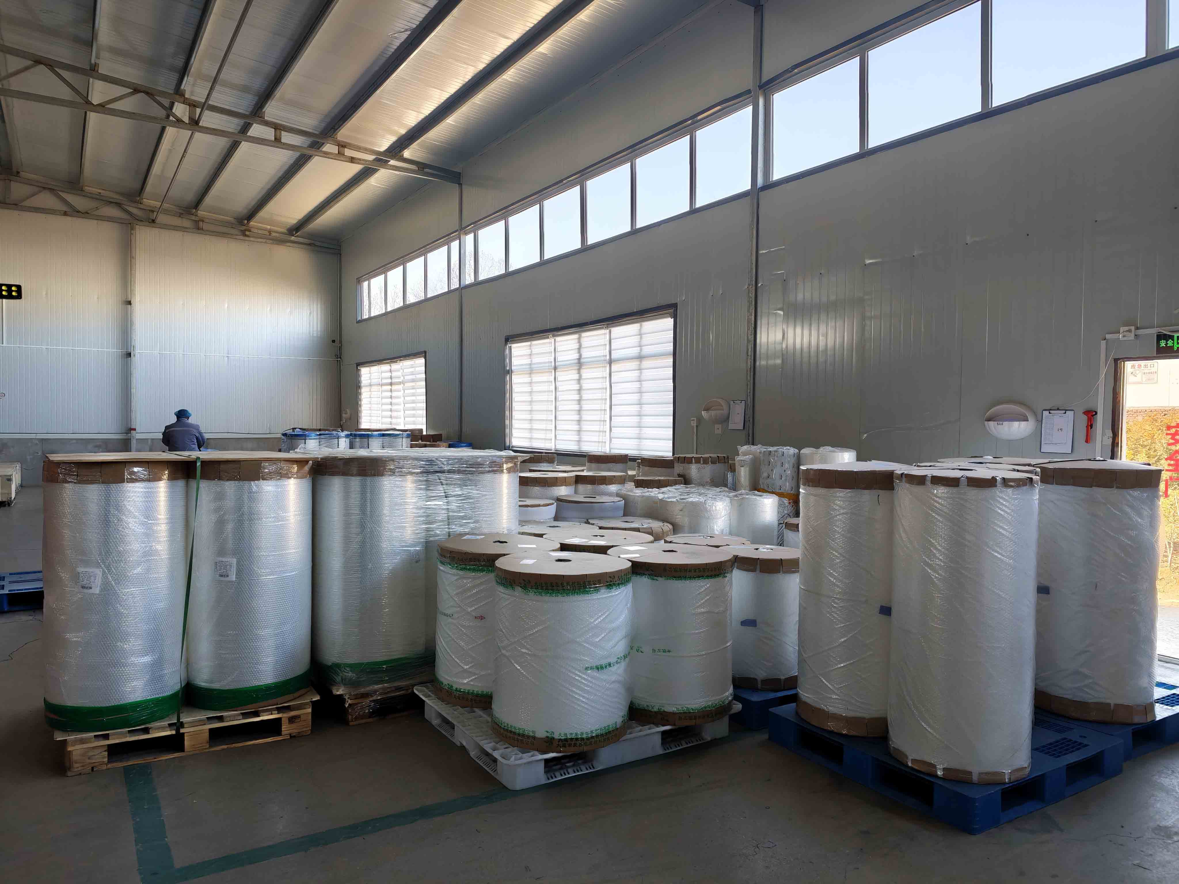 Material film rolls stored on pallets in the packaging factory warehouse